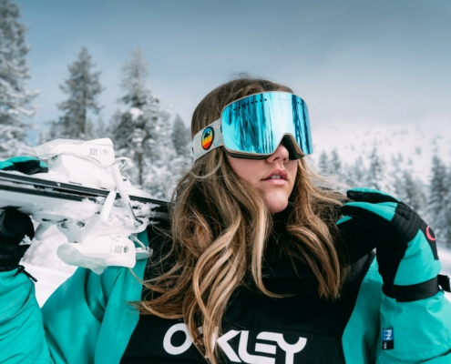 woman in black and white adidas jacket wearing blue sunglasses