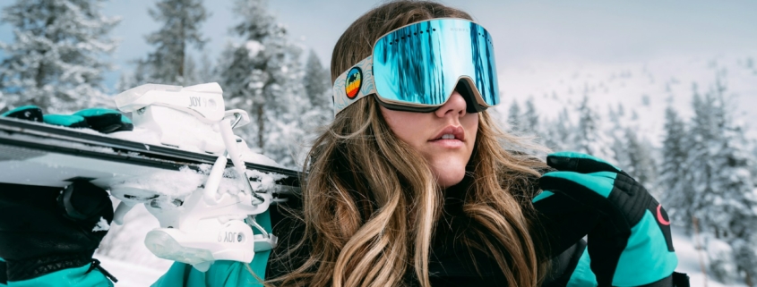 woman in black and white adidas jacket wearing blue sunglasses