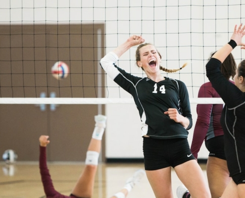 women playing volleyball inside court