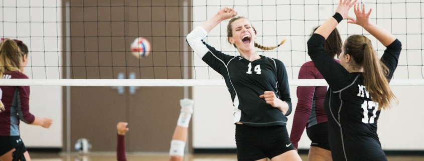 women playing volleyball inside court