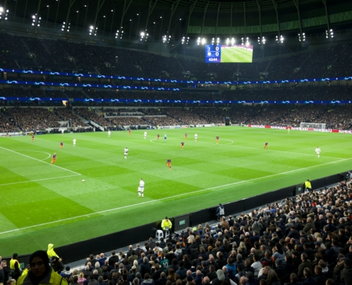 two teams playing soccer inside stadium