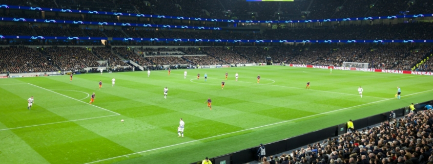 two teams playing soccer inside stadium