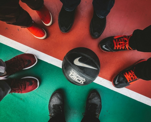 five persons standing in front of black and white Nike basketball