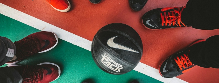 five persons standing in front of black and white Nike basketball