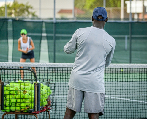 a man and a woman playing tennis on a tennis court