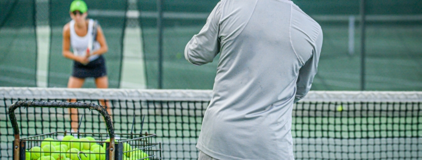 a man and a woman playing tennis on a tennis court