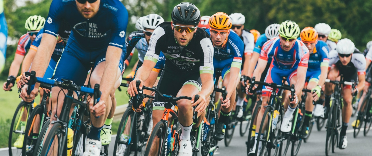 group of cyclist on asphalt road