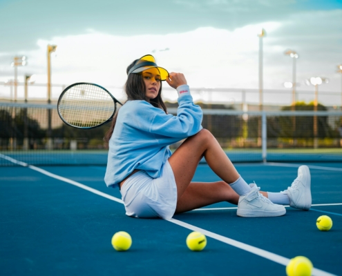 woman in blue dress sitting on tennis court